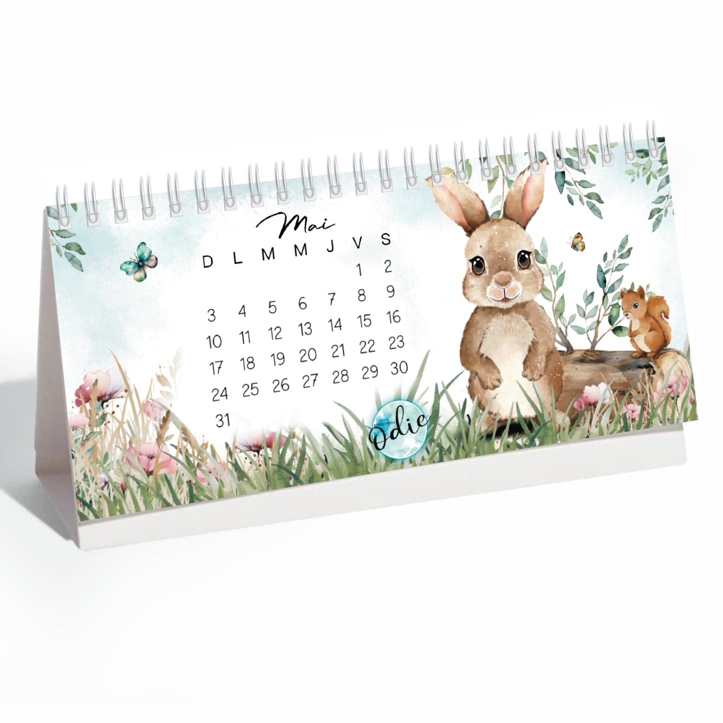 Calendrier mural 2026 spiralé illustré à la main par Odie, avec des dessins inspirés de la nature et des saisons, imprimé au Québec.