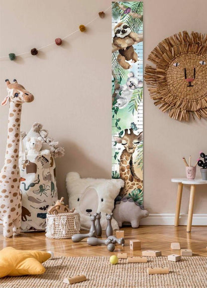 Échelle de croissance jungle installée dans une chambre d'enfant avec déco animaux et jouets